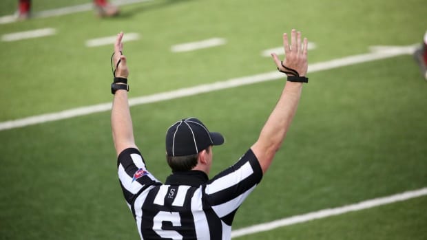A referee signals for a New Mexico State touchdown against Dixie State in a college football game on Sunday, March 7, 2021 at the Sun Bowl in El Paso, Texas.